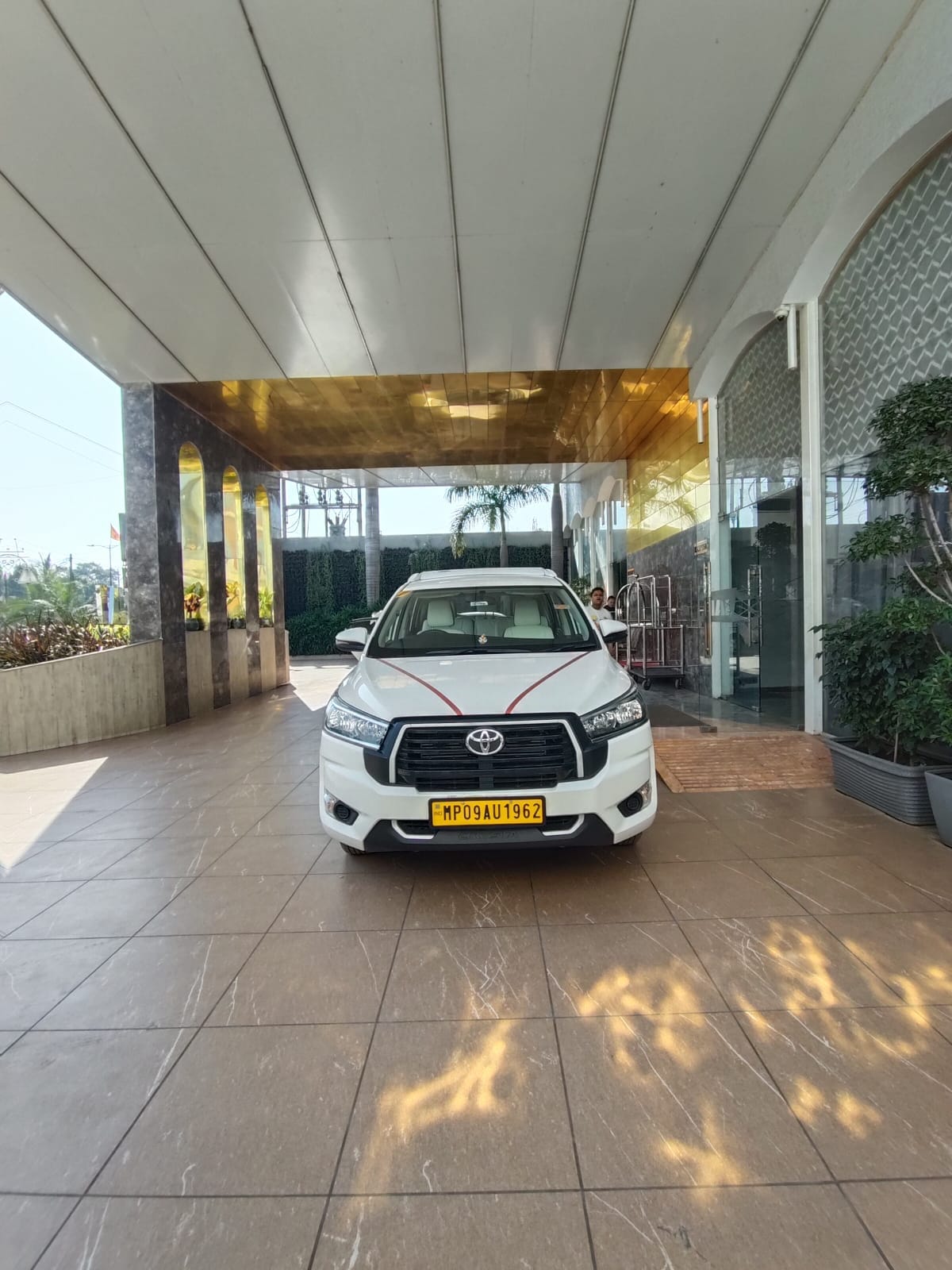 IndoreCab chauffeur-driven Toyota Innova Crysta arriving at a hotel entrance